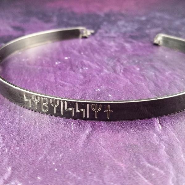 Share a secret. Rune font creates a unique collar with a secret message. The outside inscription is engraved in Rune symbols for Submissive, and the inside is engraved  with your choice of inscription