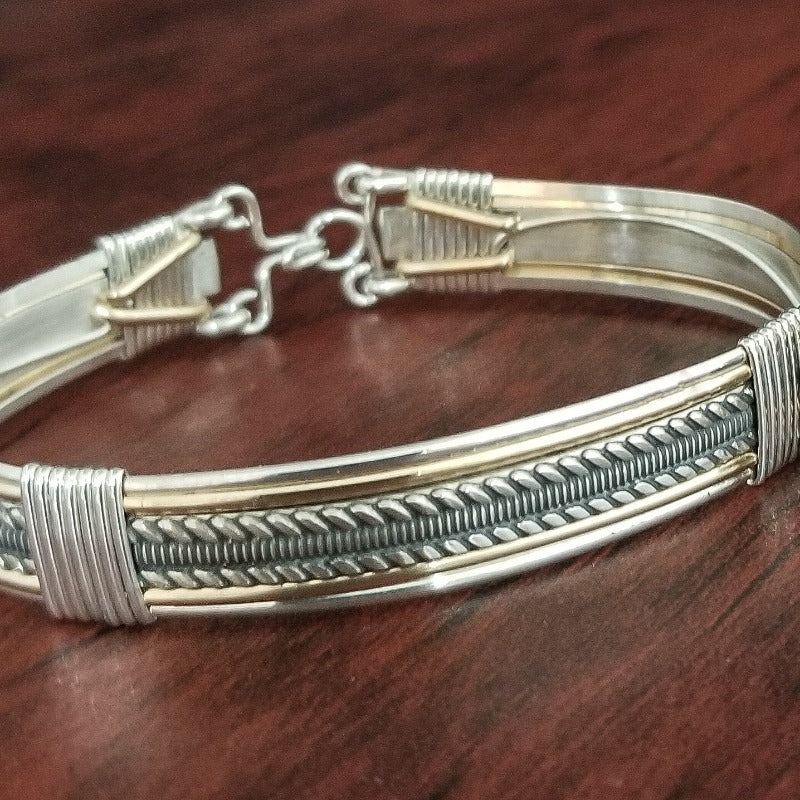 Our Rigger Collection is themed around ropes, paying homage to the ancient art of shibari. Designed for the Dominant, this bracelet has a traditional hook clasp. Created with sterling with slim bands of 14k gold filled accents.