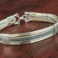 Our Rigger Collection is themed around ropes, paying homage to the ancient art of shibari. Designed for the Dominant, this bracelet has a traditional hook clasp. Created with sterling with slim bands of 14k gold filled accents.