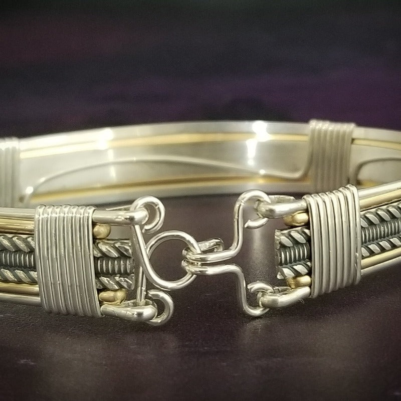 Our Rigger Collection is themed around ropes, paying homage to the ancient art of shibari. Designed for the Dominant, this bracelet has a traditional hook clasp. Created with sterling with slim bands of 14k gold filled accents.