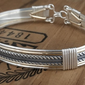 Our Rigger Collection is themed around ropes, paying homage to the ancient art of shibari. Designed for the Dominant, this bracelet has a traditional hook clasp. Created with sterling with slim bands of 14k gold filled accents.