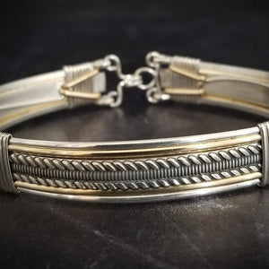 Our Rigger Collection is themed around ropes, paying homage to the ancient art of shibari. Designed for the Dominant, this bracelet has a traditional hook clasp. Created with sterling with slim bands of 14k gold filled accents.