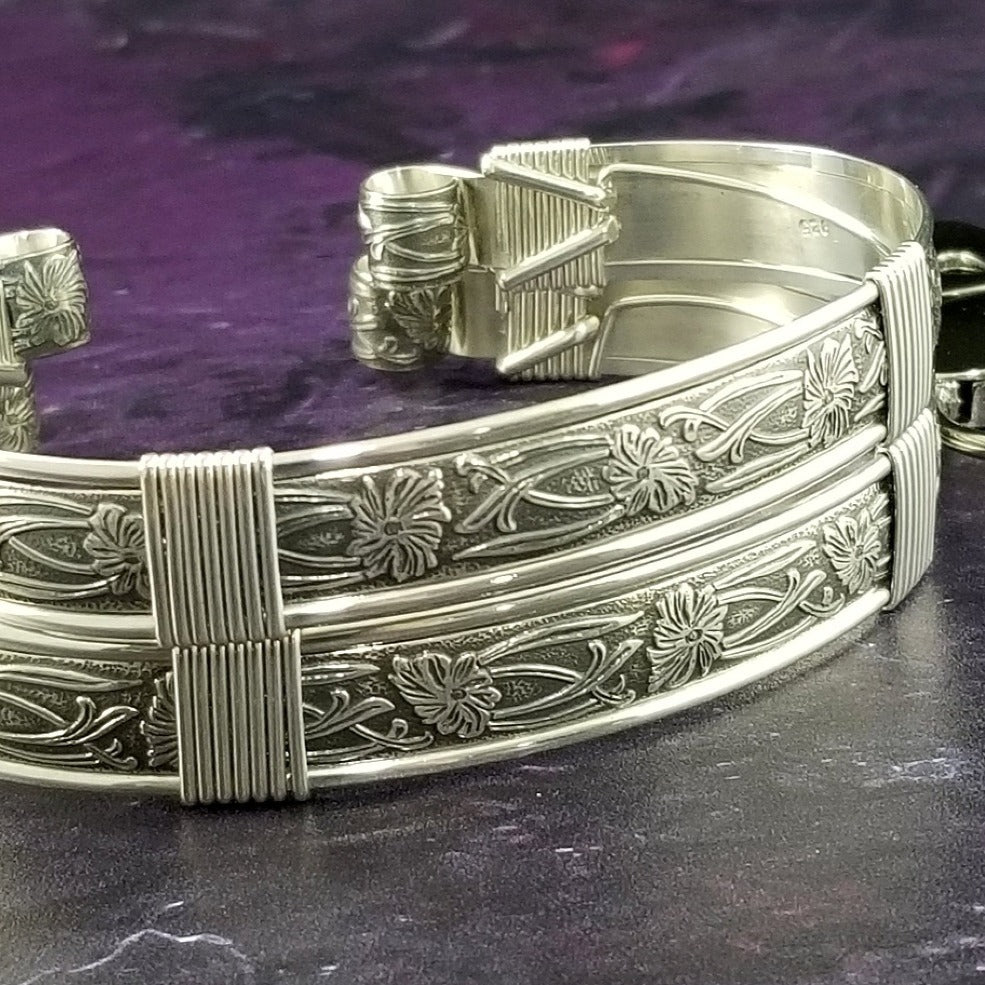 Our best-selling design ... Show your ownership/submission with style and grace. The Soft and Sweet Submissive Collection is the epitome of feminine beauty. This timeless floral pattern is solid sterling silver and hand wrapped with sterling silver accents. Worn as discreet, beautiful matching bracelets, no one will know your secret. 