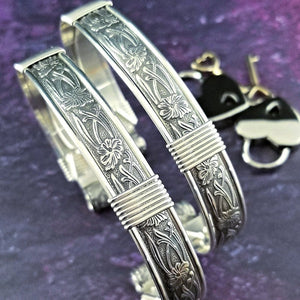 Our best-selling design ... Show your ownership/submission with style and grace. The Soft and Sweet Submissive Collection is the epitome of feminine beauty. This timeless floral pattern is solid sterling silver and hand wrapped with sterling silver accents. Worn as discreet, beautiful matching bracelets, no one will know your secret. 