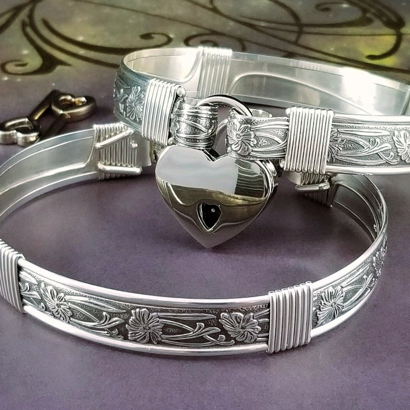 Our best-selling design ... Show your ownership/submission with style and grace. The Soft and Sweet Submissive Collection is the epitome of feminine beauty. This timeless floral pattern is solid sterling silver and hand wrapped with sterling silver accents. Worn as discreet, beautiful matching bracelets, no one will know your secret. 