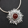 Dramatic Fire pendant with hand set with a  gemstone cabochon in your choice of black onyx, carnelian or moonstone. The pendant is sterling silver, the bail is silver plated. Can be worn as a pendant on a chain, or slide onto most all or our artisan collars.