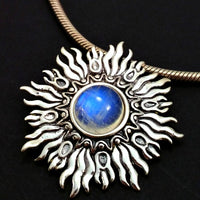Dramatic Fire pendant with hand set with a  gemstone cabochon in your choice of black onyx, carnelian or moonstone. The pendant is sterling silver, the bail is silver plated. Can be worn as a pendant on a chain, or slide onto most all or our artisan collars.