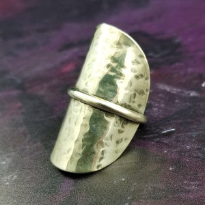 Minimalist style meets a bold design. Inspired to be a bold statement alone, yet will compliment any and all of your other jewelry. The top medallion is hand cut and hammered, then wrapped with a slim band of silver. It curves and hugs the top and sides of the finger for a all-day comfortable fit. 