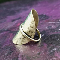 Minimalist style meets a bold design. Inspired to be a bold statement alone, yet will compliment any and all of your other jewelry. The top medallion is hand cut and hammered, then wrapped with a slim band of silver. It curves and hugs the top and sides of the finger for a all-day comfortable fit. 