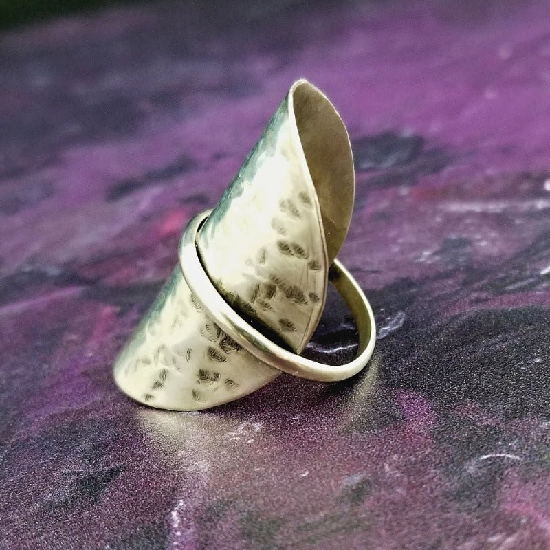 Minimalist style meets a bold design. Inspired to be a bold statement alone, yet will compliment any and all of your other jewelry. The top medallion is hand cut and hammered, then wrapped with a slim band of silver. It curves and hugs the top and sides of the finger for a all-day comfortable fit. 
