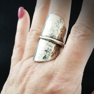 Minimalist style meets a bold design. Inspired to be a bold statement alone, yet will compliment any and all of your other jewelry. The top medallion is hand cut and hammered, then wrapped with a slim band of silver. It curves and hugs the top and sides of the finger for a all-day comfortable fit. 