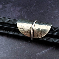 Minimalist style meets a bold design. Inspired to be a bold statement alone, yet will compliment any and all of your other jewelry. The top medallion is hand cut and hammered, then wrapped with a slim band of silver. It curves and hugs the top and sides of the finger for a all-day comfortable fit. 