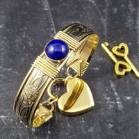 Gold and Lapis. What a luxurious way to show your Ownership / submission. Beautifully feminine and romantic locking handcuffs or anklets. This addition to our SOFT and SWEET Collection is created in precious metals and and all natural gemstones accented with coordinating wire accents. BDSM has never been so luxurious.