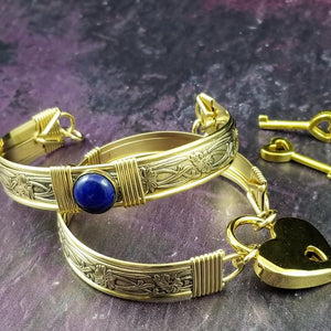 Gold and Lapis. What a luxurious way to show your Ownership / submission. Beautifully feminine and romantic locking handcuffs or anklets. This addition to our SOFT and SWEET Collection is created in precious metals and and all natural gemstones accented with coordinating wire accents. BDSM has never been so luxurious.