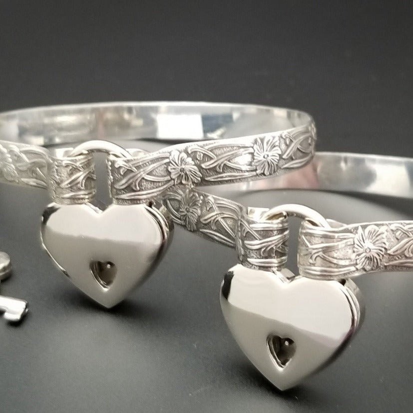 These artisan handcuffs / ankle restraints are hand crafted in a pretty feminine floral pattern that is the epitome of feminine grace. 