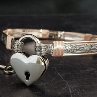 Show your ownership or submission with style and grace. Our best selling ‘SOFT and SWEET’ Locking BDSM submissive collar is now available in Sterling Silver with Rose Gold Accents. This artisan collar is hand crafted in a pretty feminine floral pattern that is the epitome of feminine grace. 
