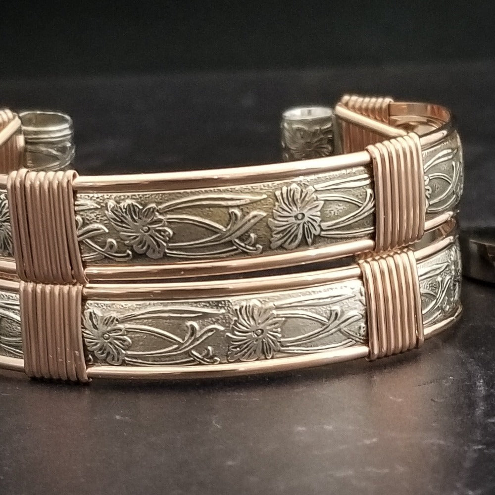 Show your ownership or submission with style and grace. Our best selling ‘SOFT and SWEET’ Locking BDSM submissive handcuff bracelets are now available in Sterling Silver with Rose Gold Accents. These artisan handcuffs are hand crafted in a pretty feminine floral pattern that is the epitome of feminine grace. 
