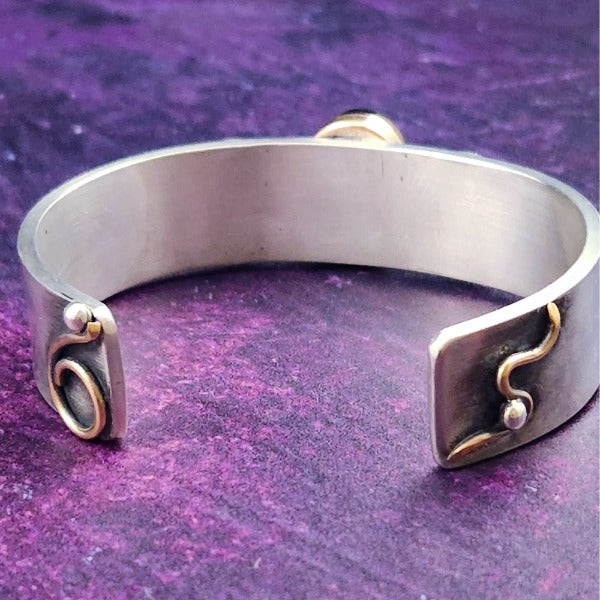 An exotic looking cobalt colored window druzy cabochon is set into a bronze setting, then surrounded by sterling silver crescent moons.  Sterling Silver Cuff bracelet is really hefty and accented with 14k Gold-Filled wire accents.
