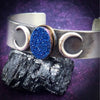 An exotic looking cobalt colored window druzy cabochon is set into a bronze setting, then surrounded by sterling silver crescent moons.  Sterling Silver Cuff bracelet is really hefty and accented with 14k Gold-Filled wire accents.