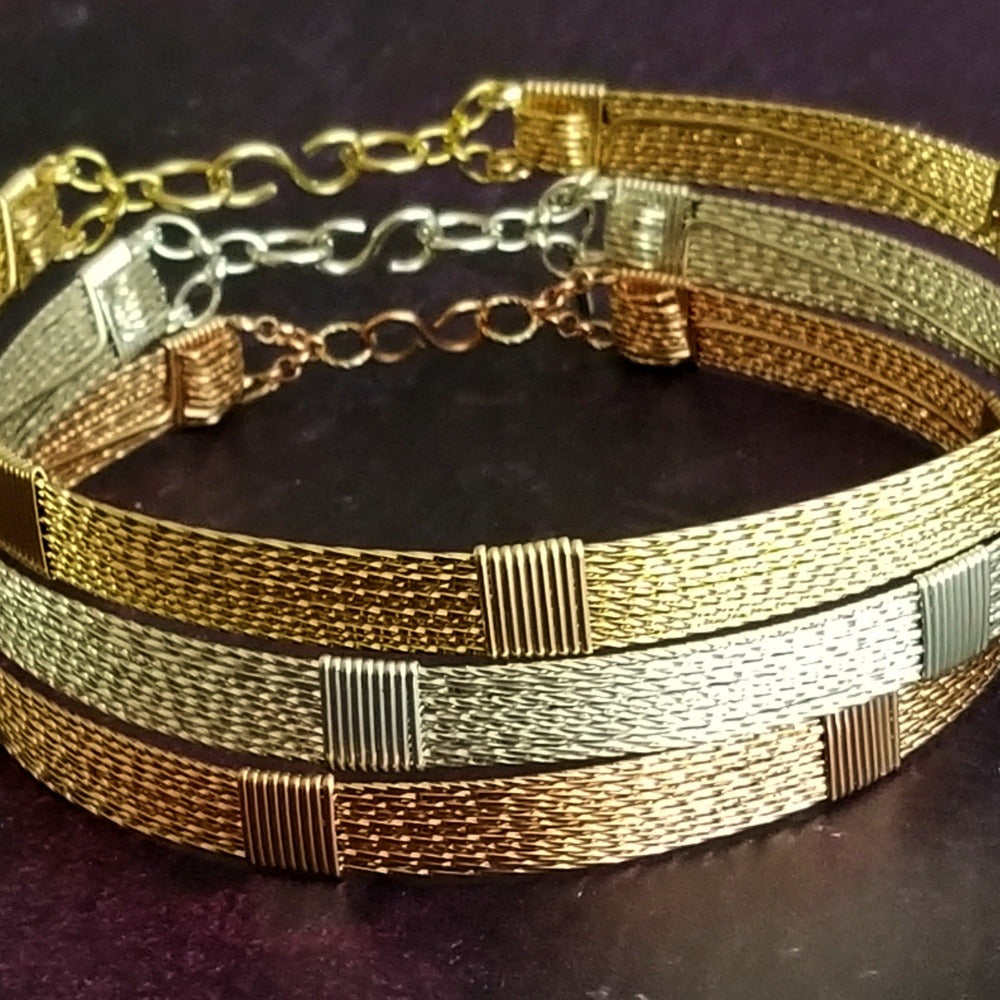 Showcase your power and taste with ASHANTI Slim Collar. This handcrafted collar is artfully crafted with twisted 14K gold filled wire and elevated with gold wraps. A touch of chain in the back ensures a snug fit, so you can move with ease. Wear ASHANTI TWISTED alone or layer it with other chains and pendants--it's the perfect foundation for building endless elegant looks! Plus, the locking collar takes your look up a notch. 