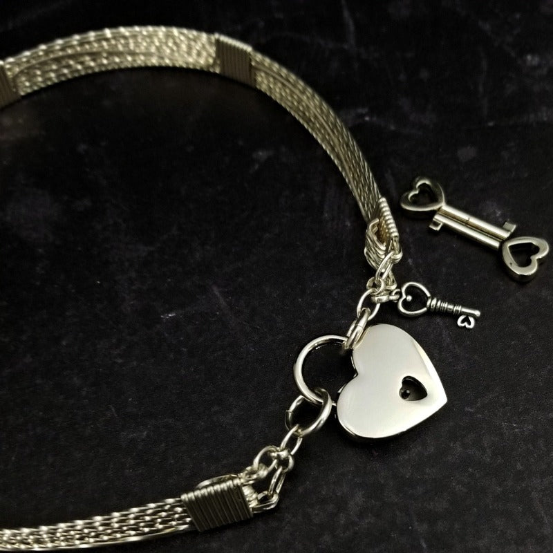 This ASHANTI Slim BDSM Submissive Collar is masterfully crafted from Sterling Silver, offering unparalleled artistry and lasting beauty. Its timeless design makes it the perfect addition to any BDSM enthusiast's collection, ensuring that you can cherish it for years to come.