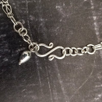 A beautiful symbol of your D/s dynamic, this contemporary V Style Locking BDSM submissive collar is hand crafted in mixed precious metals of sterling silver and gold. As strong and beautiful as the submissive’s heart, this high-quality artisan collar is made to last and will be the foundation of your private collection