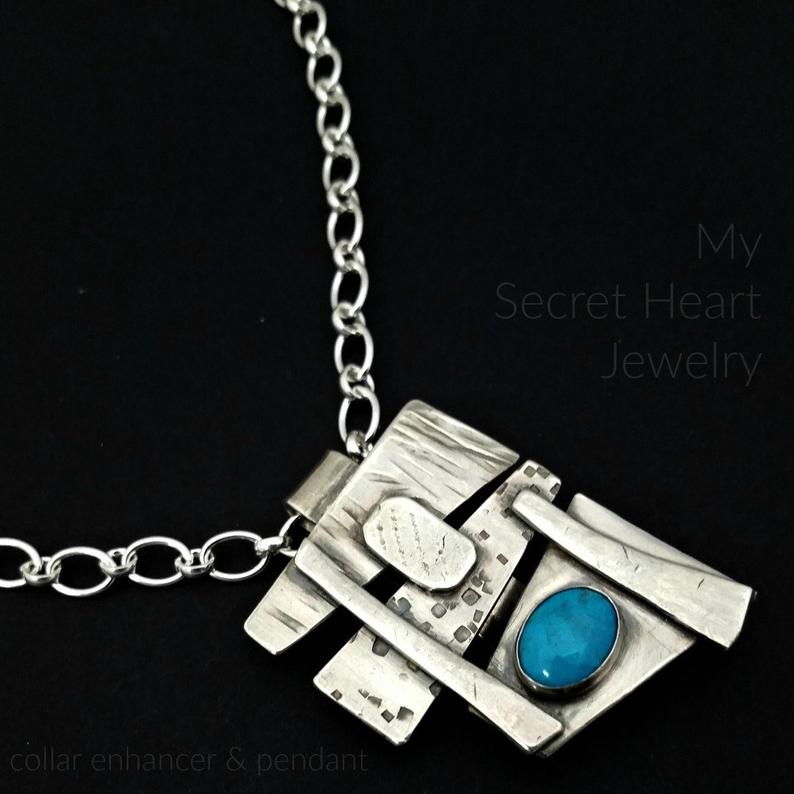 Add some personality to your collar. This collar slide is handcrafted in sterling silver with a bezel set Turquoise cabochon. A very Asian inspired asymmetrical design. The pendant comes with a sterling silver chain, but the unique clip design allows you to also clip the pendant over your own beaded necklaces for a dramatic and unique style.