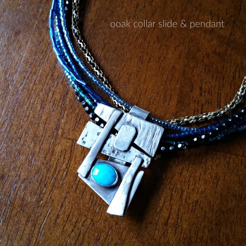 Add some personality to your collar. This collar slide is handcrafted in sterling silver with a bezel set Turquoise cabochon. A very Asian inspired asymmetrical design. The pendant comes with a sterling silver chain, but the unique clip design allows you to also clip the pendant over your own beaded necklaces for a dramatic and unique style.