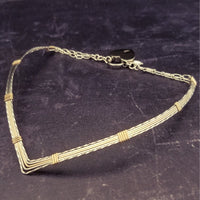 A beautiful symbol of your D/s dynamic, this contemporary V Style Locking BDSM submissive collar is hand crafted in mixed precious metals of sterling silver and gold. As strong and beautiful as the submissive’s heart, this high-quality artisan collar is made to last and will be the foundation of your private collection