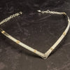 A beautiful symbol of your D/s dynamic, this contemporary V Style Locking BDSM submissive collar is hand crafted in mixed precious metals of sterling silver and gold. As strong and beautiful as the submissive’s heart, this high-quality artisan collar is made to last and will be the foundation of your private collection