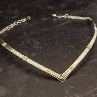 A beautiful symbol of your D/s dynamic, this contemporary V Style Locking BDSM submissive collar is hand crafted in mixed precious metals of sterling silver and gold. As strong and beautiful as the submissive’s heart, this high-quality artisan collar is made to last and will be the foundation of your private collection