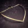 A beautiful symbol of your D/s dynamic, this contemporary V Style Locking BDSM submissive collar is hand crafted in mixed precious metals of sterling silver and gold. As strong and beautiful as the submissive’s heart, this high-quality artisan collar is made to last and will be the foundation of your private collection