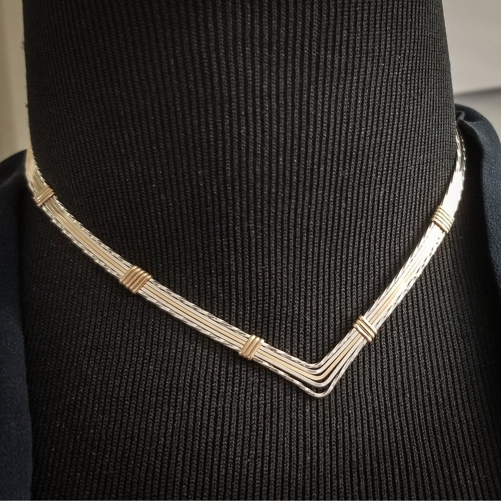 A beautiful symbol of your D/s dynamic, this contemporary V Style Locking BDSM submissive collar is hand crafted in mixed precious metals of sterling silver and gold. As strong and beautiful as the submissive’s heart, this high-quality artisan collar is made to last and will be the foundation of your private collection