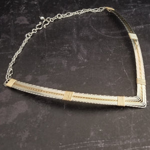 A beautiful symbol of your D/s dynamic, this contemporary V Style Locking BDSM submissive collar is hand crafted in mixed precious metals of sterling silver and gold. 