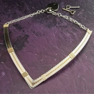 A beautiful symbol of your D/s dynamic, this contemporary V Style Locking BDSM submissive collar is hand crafted in mixed precious metals of sterling silver and gold. 