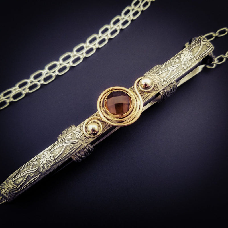 An BDSM gemstone necklace with a kinky secret. The ultimate luxury, this beauty is unlike any jewelry you've seen! The sterling silver cage holds a sleek and sexy stainless steel vibrator. So discreet, no one will ever guess. 