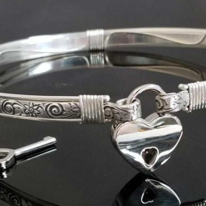The ‘WILD FLOWER’ BDSM Submissive Collar is hand crafted in Sterling Silver filled floral pattern and wrapped with sterling silver accents. Truly a high-quality artisan collar made to last; it will be a cherished addition to any collection. A beautiful symbol of a D/s relationship.