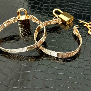 Wire wrapped submissive bracelets that are hand crafted in strands of twisted 14k gold filled and accented with 14k gold filled wraps. 