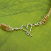 Precious metals embrace to create a seductive collection of artisan wire wrapped jewelry. Big, bold and dramatic, this unisex artisan collar is created with centuries old wire wrapping techniques, using only a few hand tools.