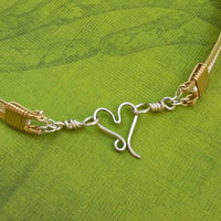 Precious metals embrace to create a seductive collection of artisan wire wrapped jewelry. Big, bold and dramatic, this unisex artisan collar is created with centuries old wire wrapping techniques, using only a few hand tools.