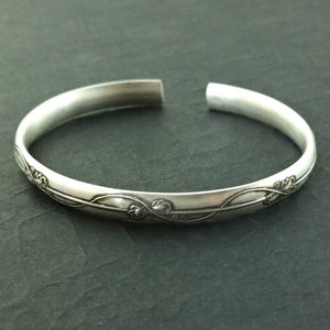 An incredibly beautiful traditional cuff inspired by the art of Alphonse Mucha, with a timeless Art Nouveau floral and vine pattern. This substantial, solid sterling silver cuff is nice and thick, measuring 6.27 mm wide x 2.84 mm thick. The edges are sanded soft, with beveled curves inside, making it oh so comfortable.