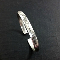 An incredibly beautiful traditional cuff inspired by the art of Alphonse Mucha, with a timeless Art Nouveau floral and vine pattern. This substantial, solid sterling silver cuff is nice and thick, measuring 6.27 mm wide x 2.84 mm thick. The edges are sanded soft, with beveled curves inside, making it oh so comfortable.