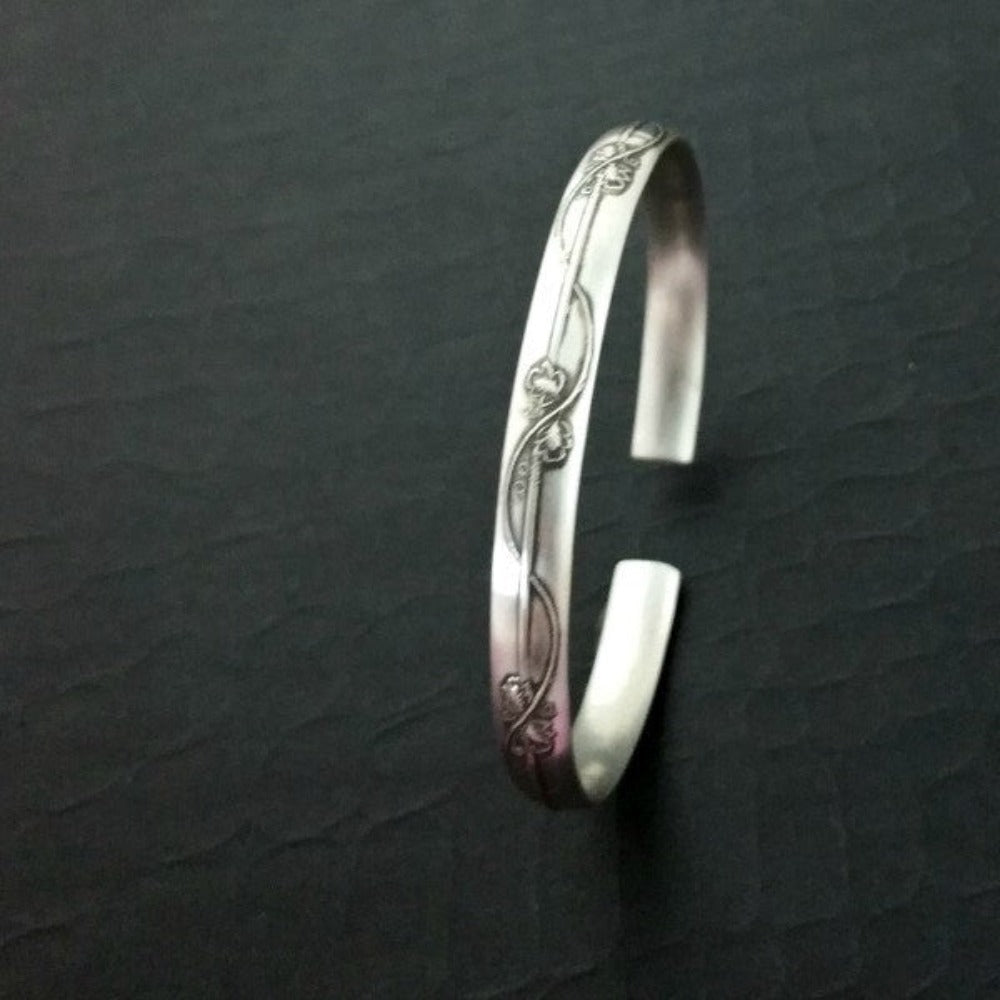 An incredibly beautiful traditional cuff inspired by the art of Alphonse Mucha, with a timeless Art Nouveau floral and vine pattern. This substantial, solid sterling silver cuff is nice and thick, measuring 6.27 mm wide x 2.84 mm thick. The edges are sanded soft, with beveled curves inside, making it oh so comfortable.