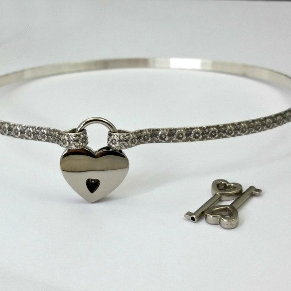 Flaunt your femininity with our sterling LOKELANI artisan submissive collar. Carefully crafted with an exquisite floral pattern and patina-finished for enhanced texture, this BDSM Locking Collar is a timeless piece of quality to be treasured and proudly displayed. Adopt this mythical rose and add to your private collection today!