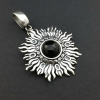 Dramatic Fire pendant with hand set with a  gemstone cabochon in your choice of black onyx, carnelian or moonstone. The pendant is sterling silver, the bail is silver plated. Can be worn as a pendant on a chain, or slide onto most all or our artisan collars.