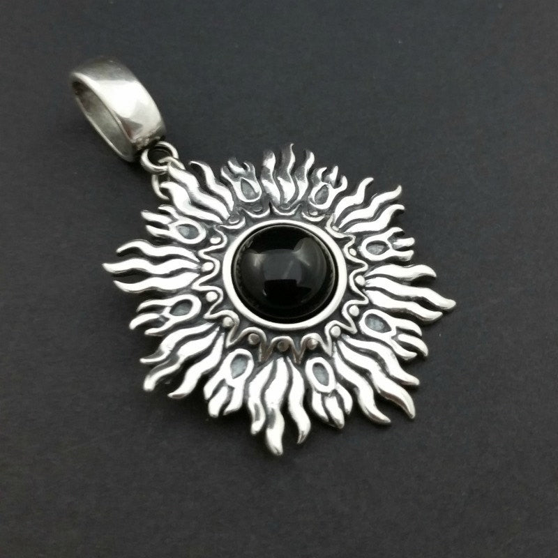 Dramatic Fire pendant with hand set with a  gemstone cabochon in your choice of black onyx, carnelian or moonstone. The pendant is sterling silver, the bail is silver plated. Can be worn as a pendant on a chain, or slide onto most all or our artisan collars.