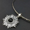 Dramatic Fire pendant with hand set with a  gemstone cabochon in your choice of black onyx, carnelian or moonstone. The pendant is sterling silver, the bail is silver plated. Can be worn as a pendant on a chain, or slide onto most all or our artisan collars.