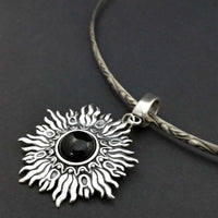 Dramatic Fire pendant with hand set with a  gemstone cabochon in your choice of black onyx, carnelian or moonstone. The pendant is sterling silver, the bail is silver plated. Can be worn as a pendant on a chain, or slide onto most all or our artisan collars.